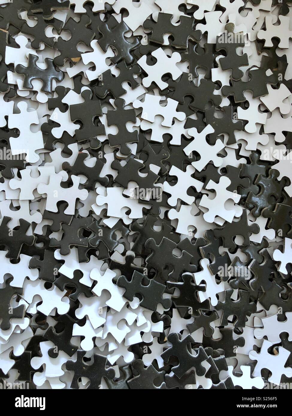 Black and white jigsaw puzzle pieces. - Smartphone Captured Stock Image