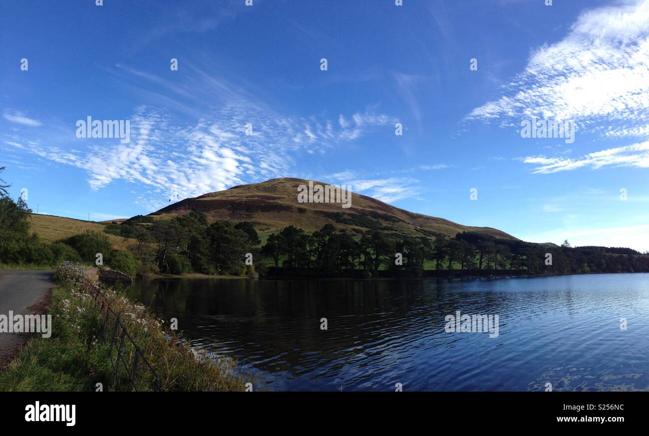 Blue skies over Scottish Loch Stock Photo