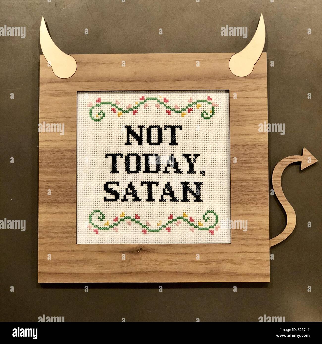 “Not today, Satan” cross stitch in wood devil frame. Stock Photo