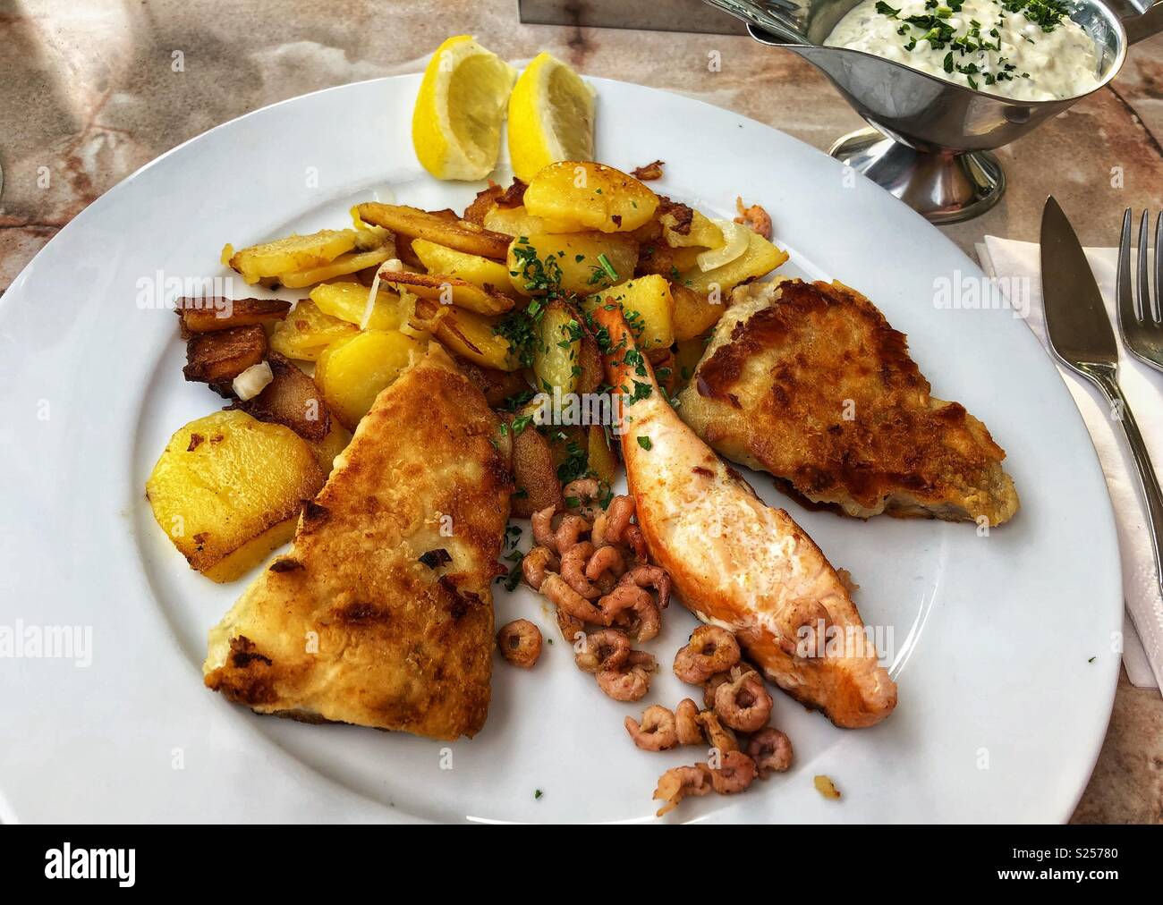 A plate of fish and potatoes, a popular northern German meal. Stock Photo