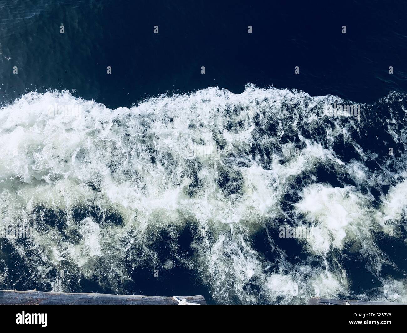 Crashing waves against a boat Stock Photo