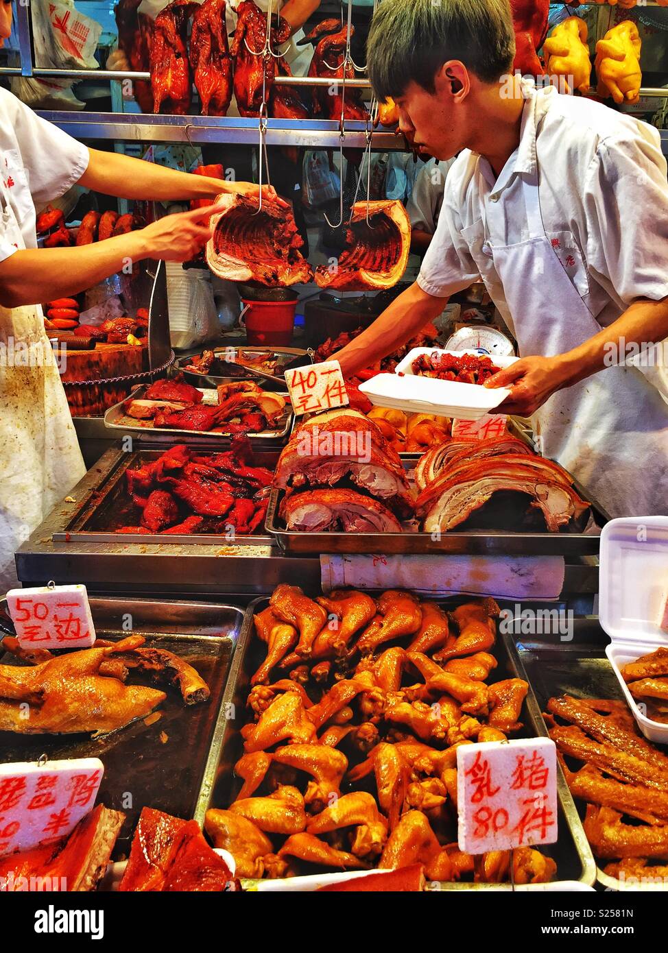 Traditional Cantonese barbequed meats and poultry, or Siu Mei, for sale in a food market, Yuen Long, New Territories, Hong Kong Stock Photo