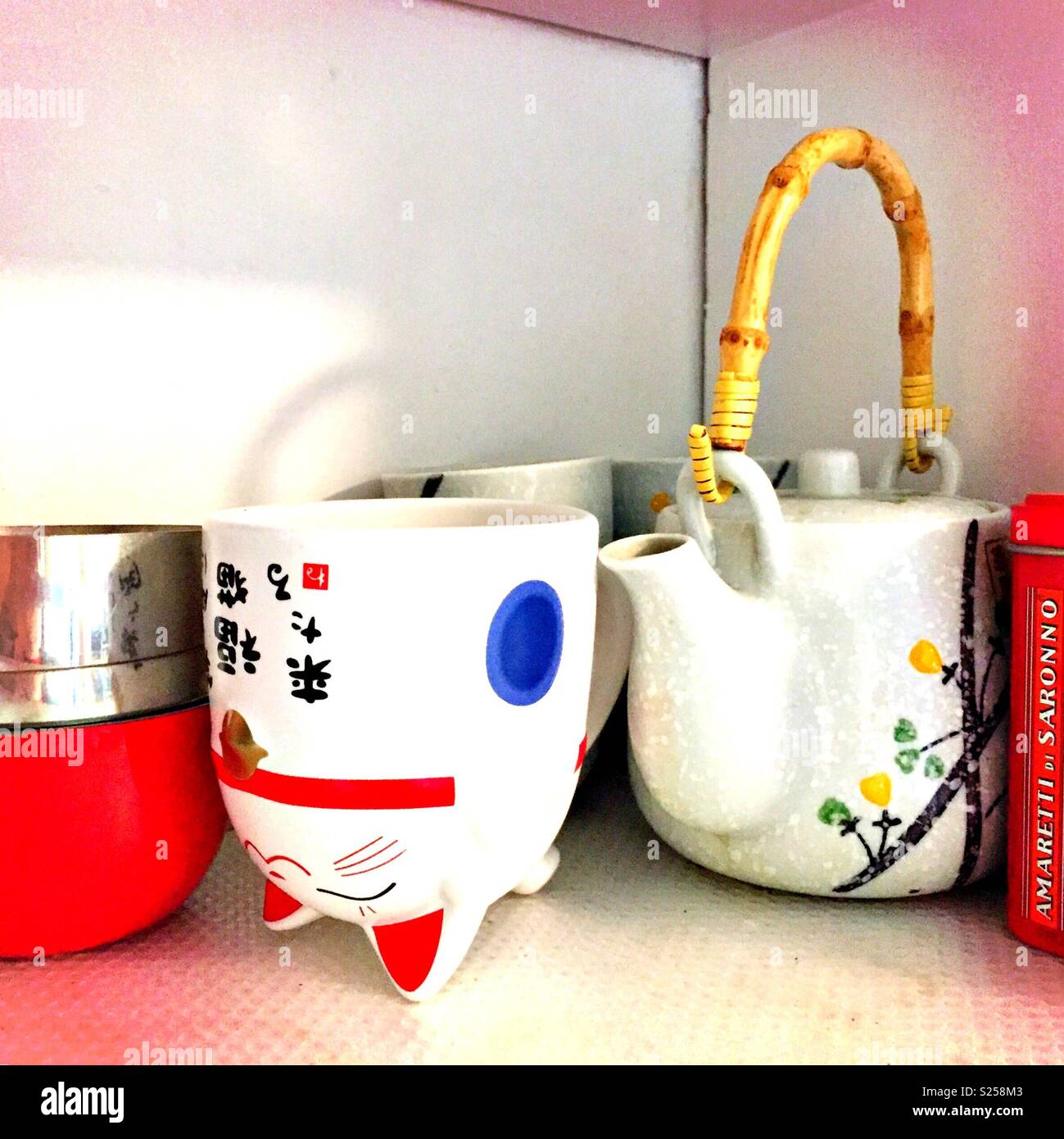 Chinese tea cups and a lucky cat mug. Stock Photo