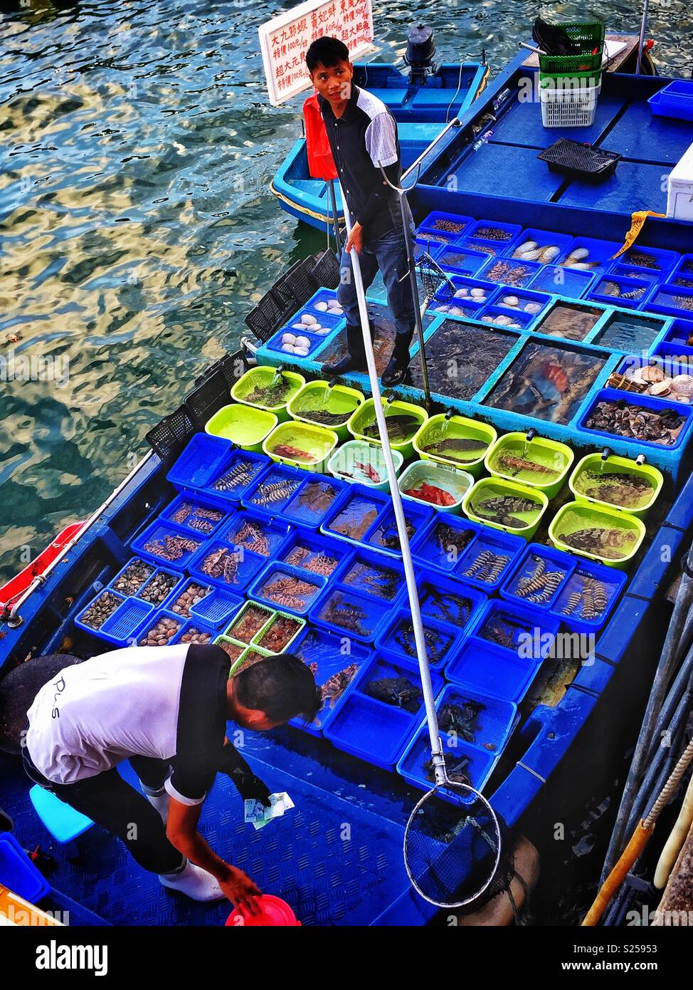 Fishermen sell locally caught fish and seafood at Sai Kung waterfront, New Territories, Hong Kong - Smartphone Captured Stock Image