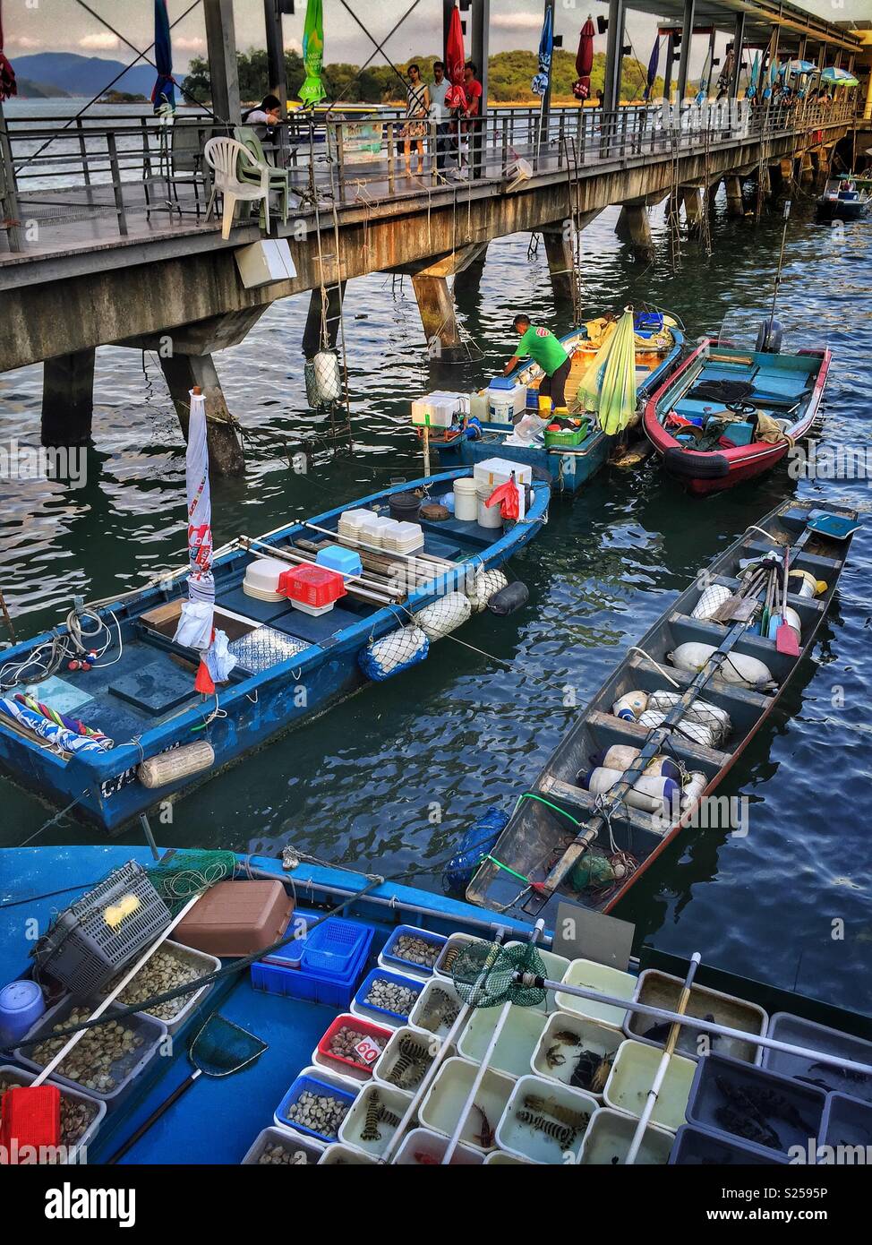 Fishermen sell locally caught fish and seafood at Sai Kung waterfront, New Territories, Hong Kong - Smartphone Captured Stock Image