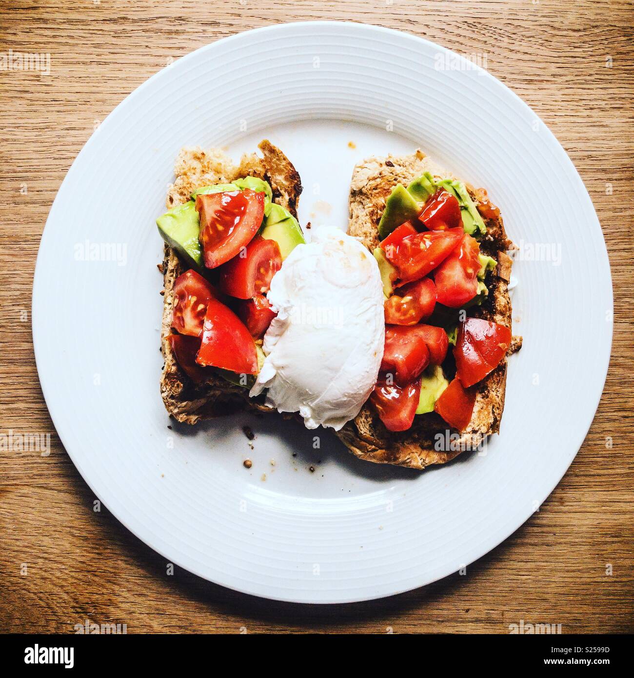 Avocado , tomato and egg on toast Stock Photo Alamy
