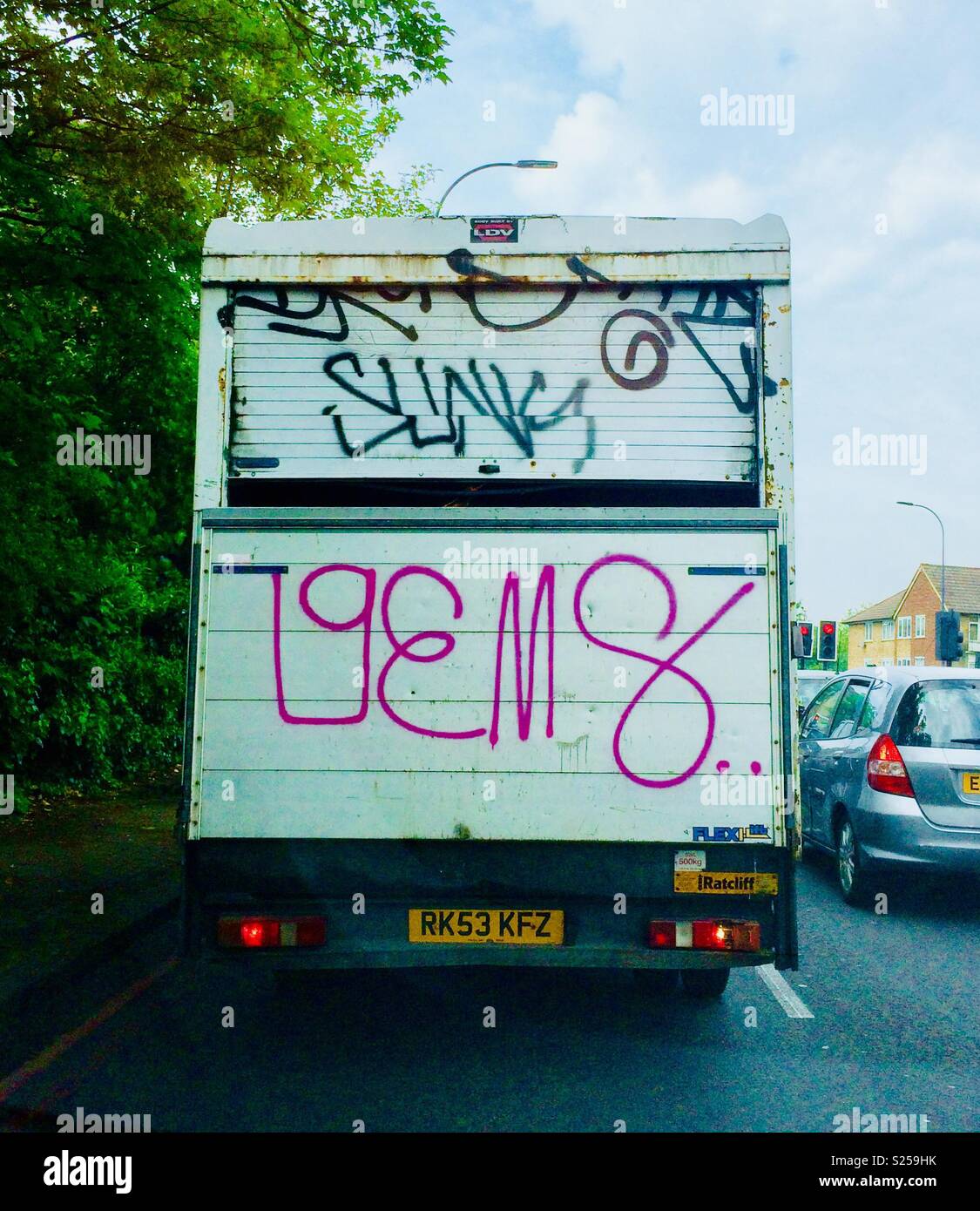 Graffiti on back of van in traffic - Smartphone Captured Stock Image