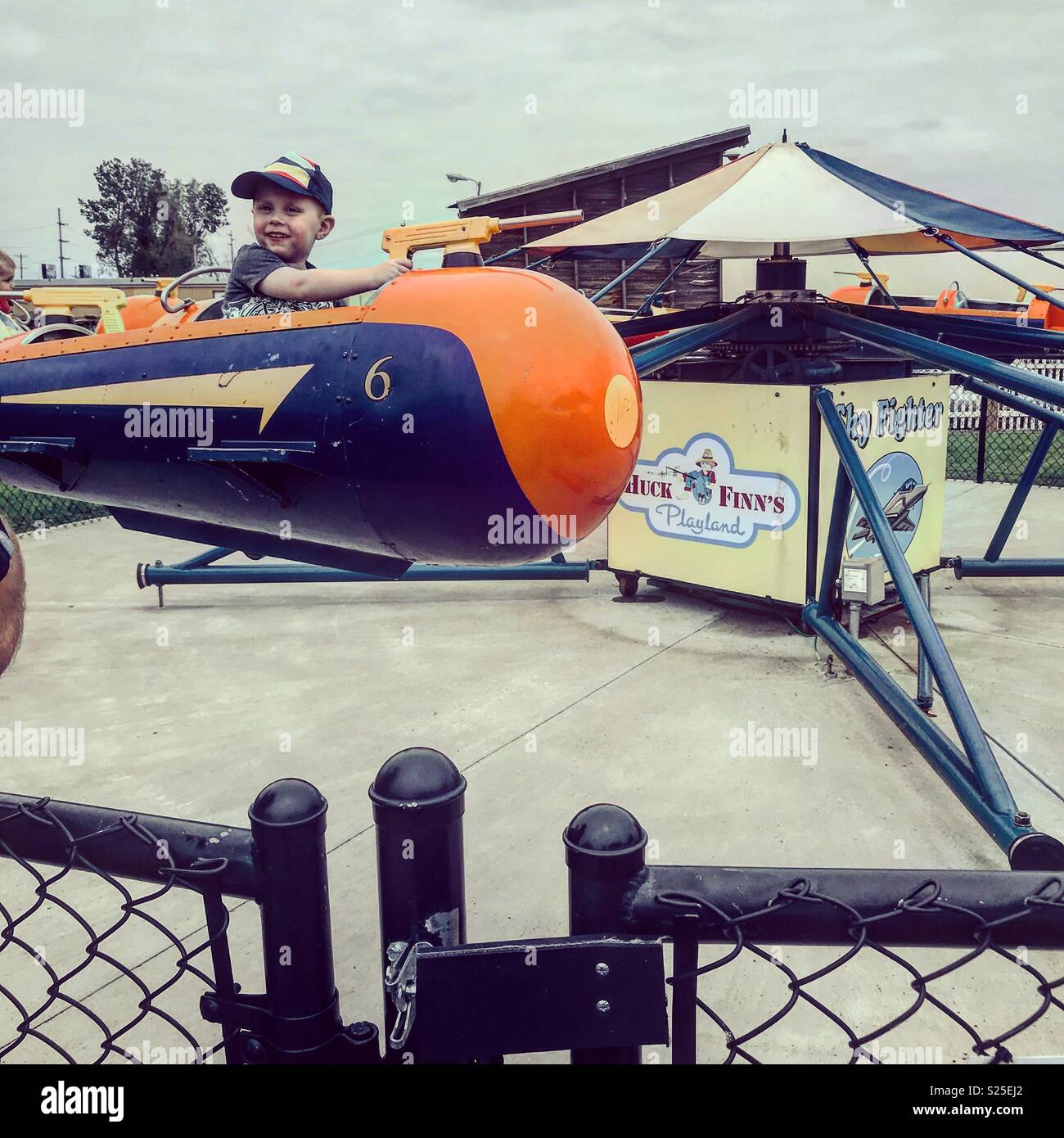 Young boy riding the Red Baron at Huck Finn’s Playland in Albany New York. Stock Photo