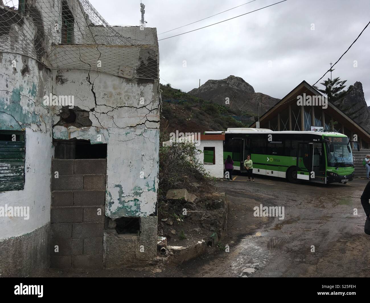Tourists leave the bus at the muddy terminus in Almáciga, Tenerife, Canary Isles Stock Photo
