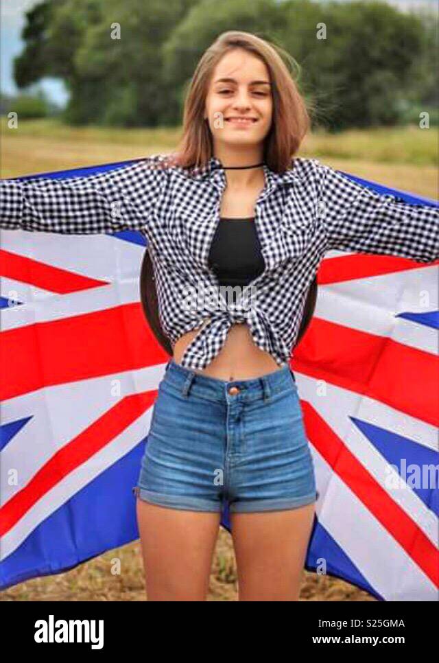 Teenager in corn field holding a union jack flag Stock Photo Alamy