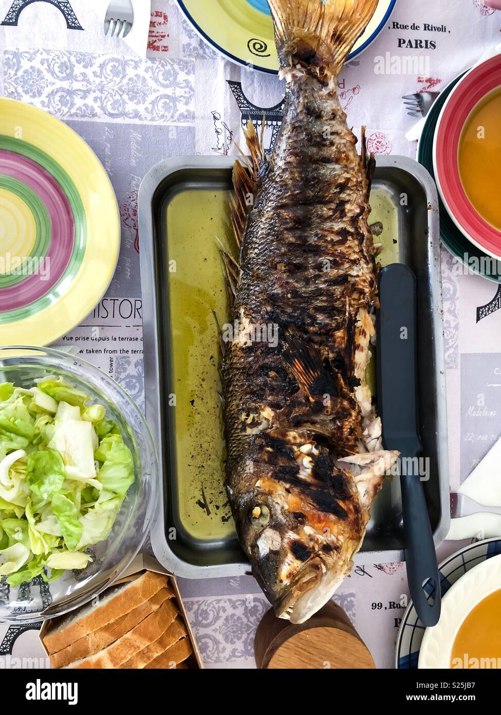Whole grilled fish with olive oil for lunch top view Stock Photo