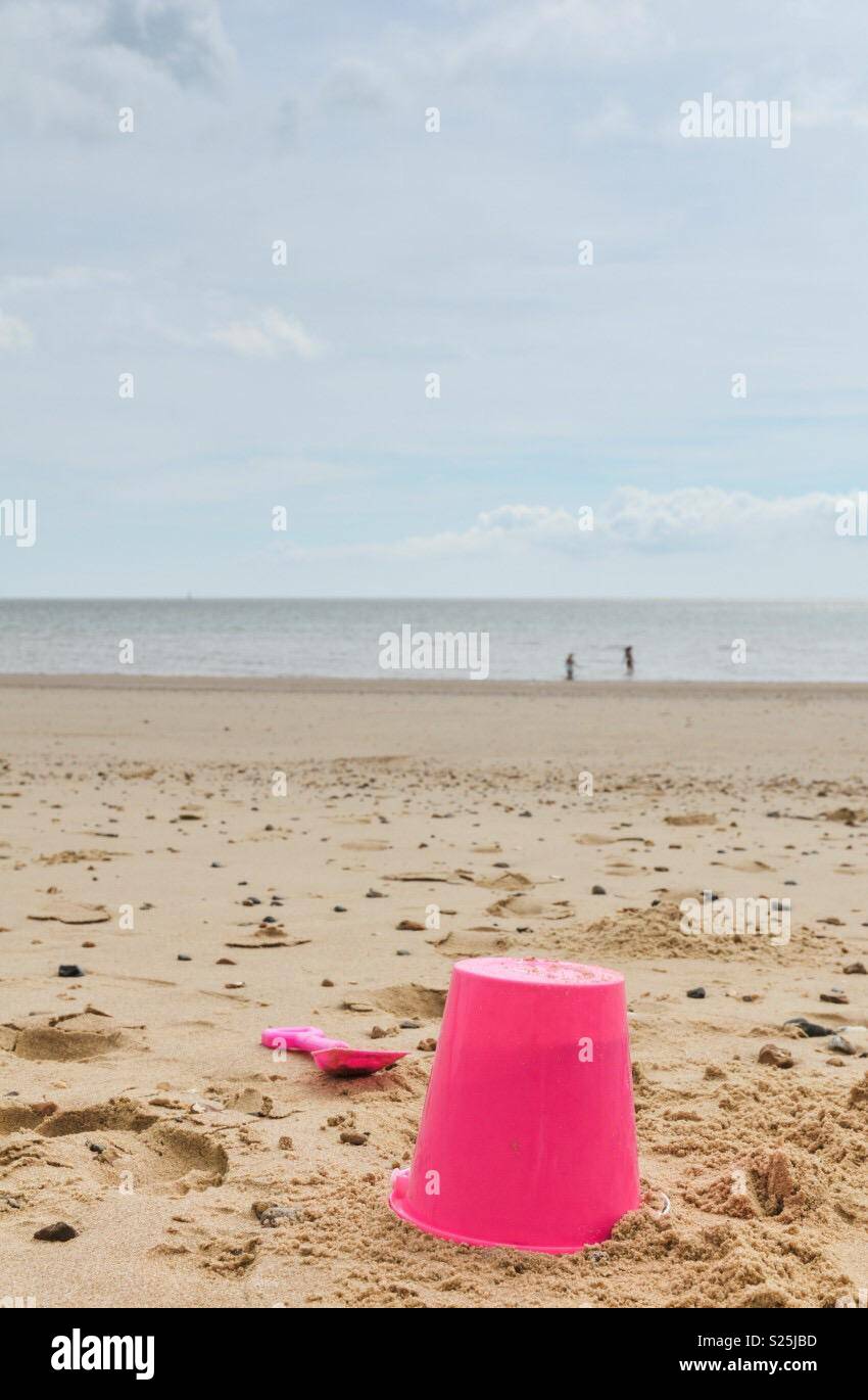 Bucket and spade on the beach Stock Photo Alamy