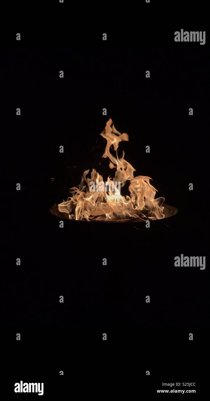 Fire in a fire pit, black background, nighttime, bright flames Stock ...