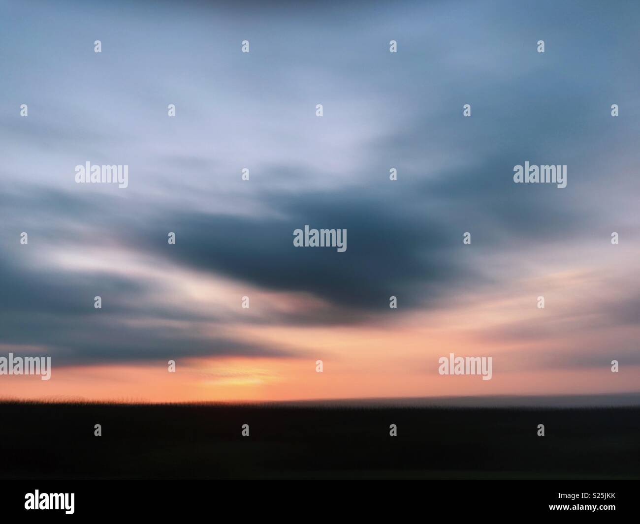 Blurred long exposure of a dusky sky during summer in rural Northumberland, England. - Smartphone Captured Stock Image