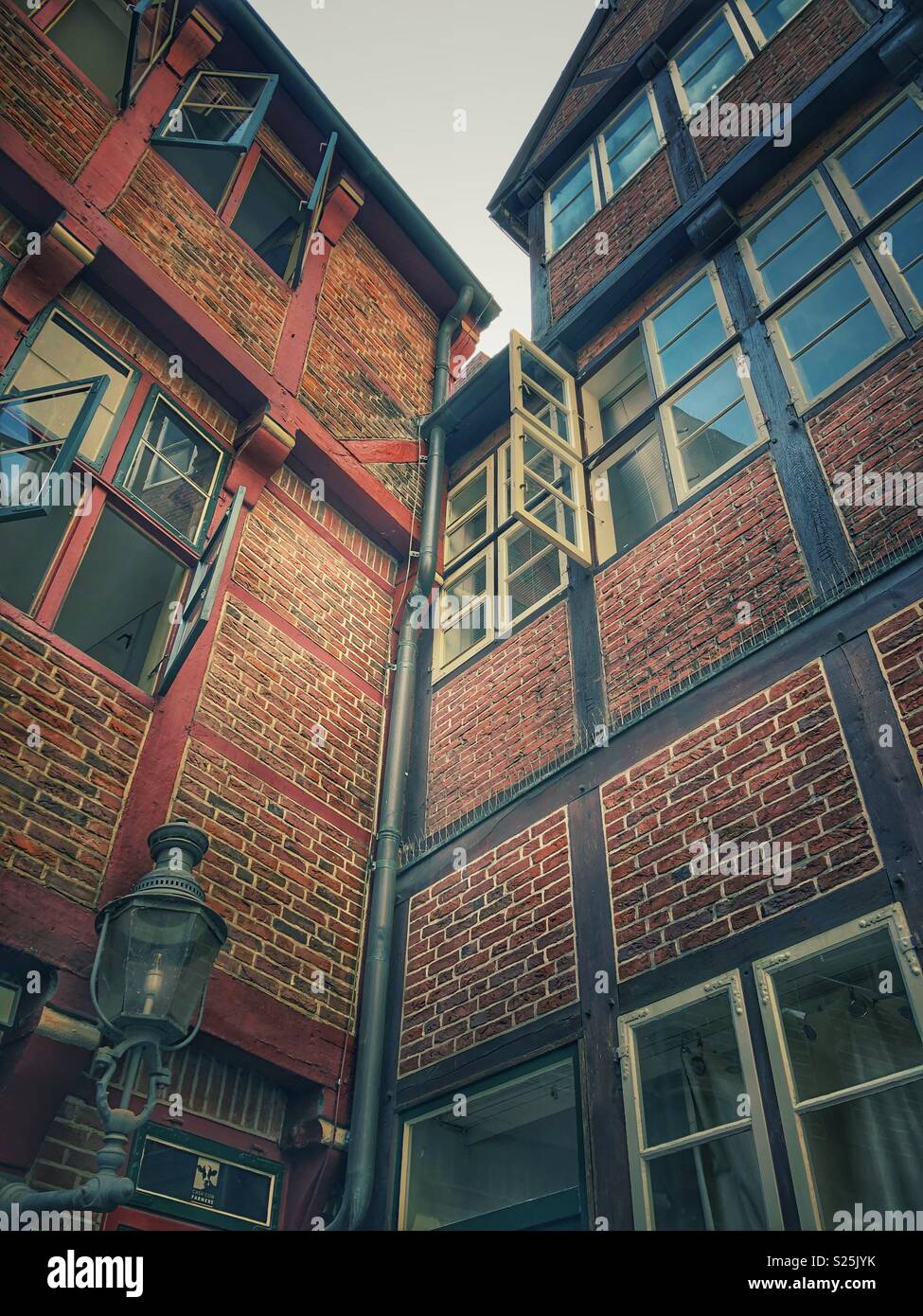Looking up at preserved heritage buildings in a historic neighbourhood in Hamburg, Germany. - Smartphone Captured Stock Image