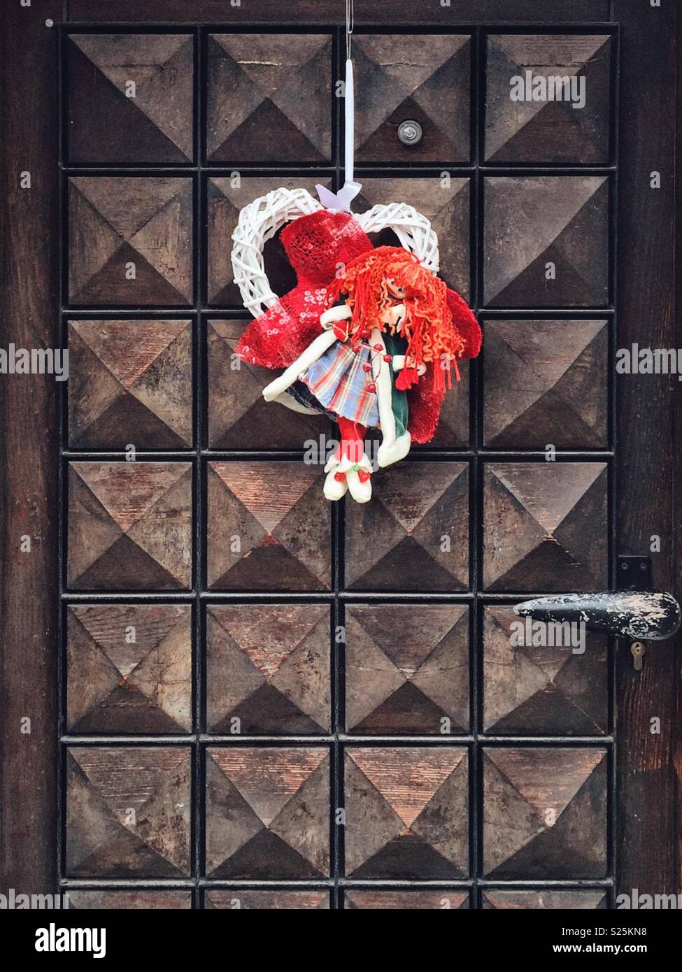 A cuddly doll hanging on a door - Smartphone Captured Stock Image