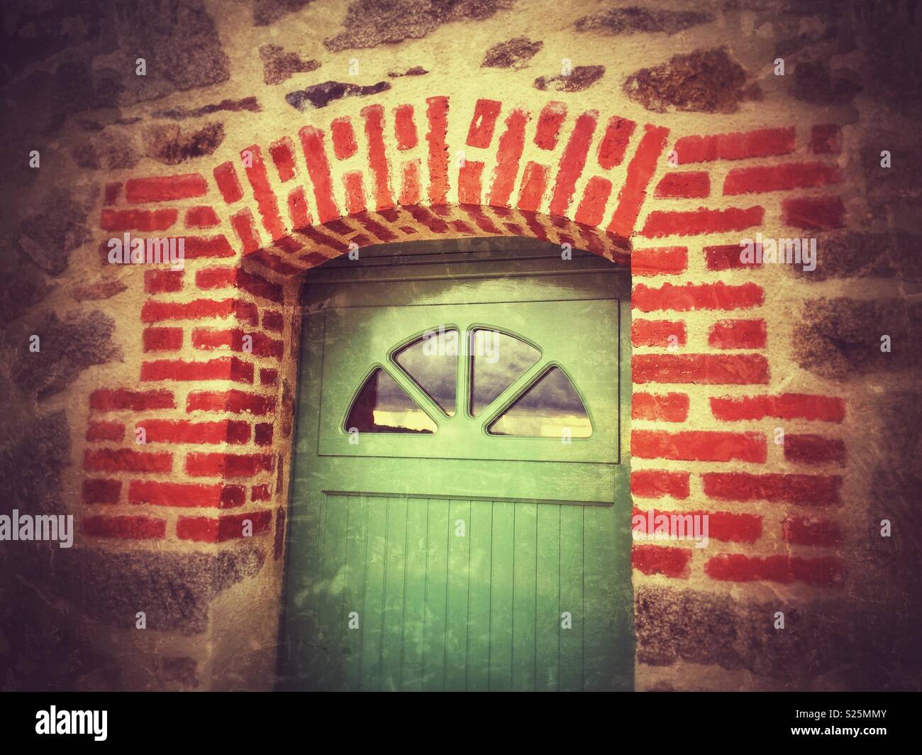 Traditional brick framed farmyard door, Cantal region, France. - Smartphone Captured Stock Image