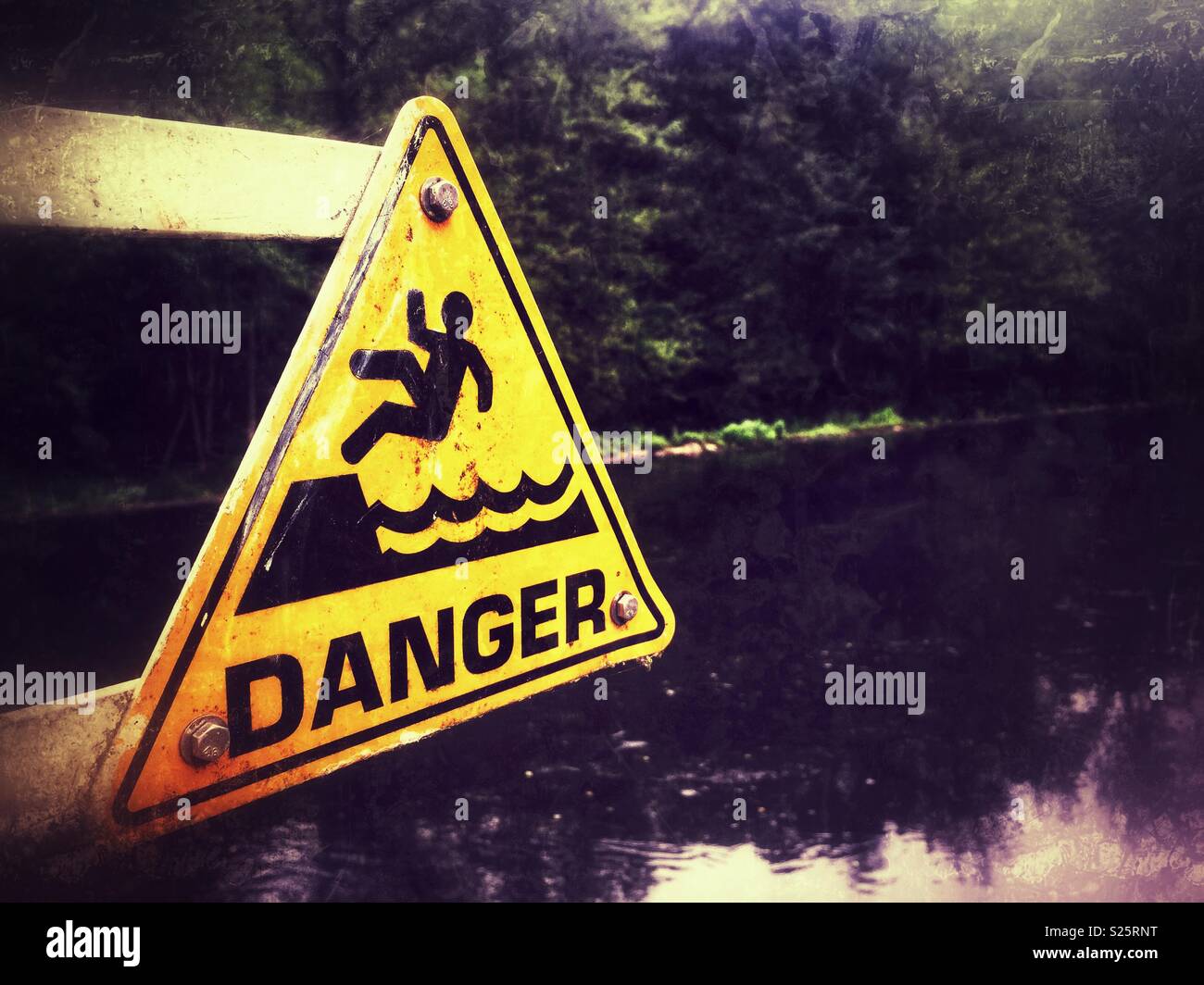 Danger deep water sign, next to flowing river, Entraygues, Cantal region, France. - Smartphone Captured Stock Image