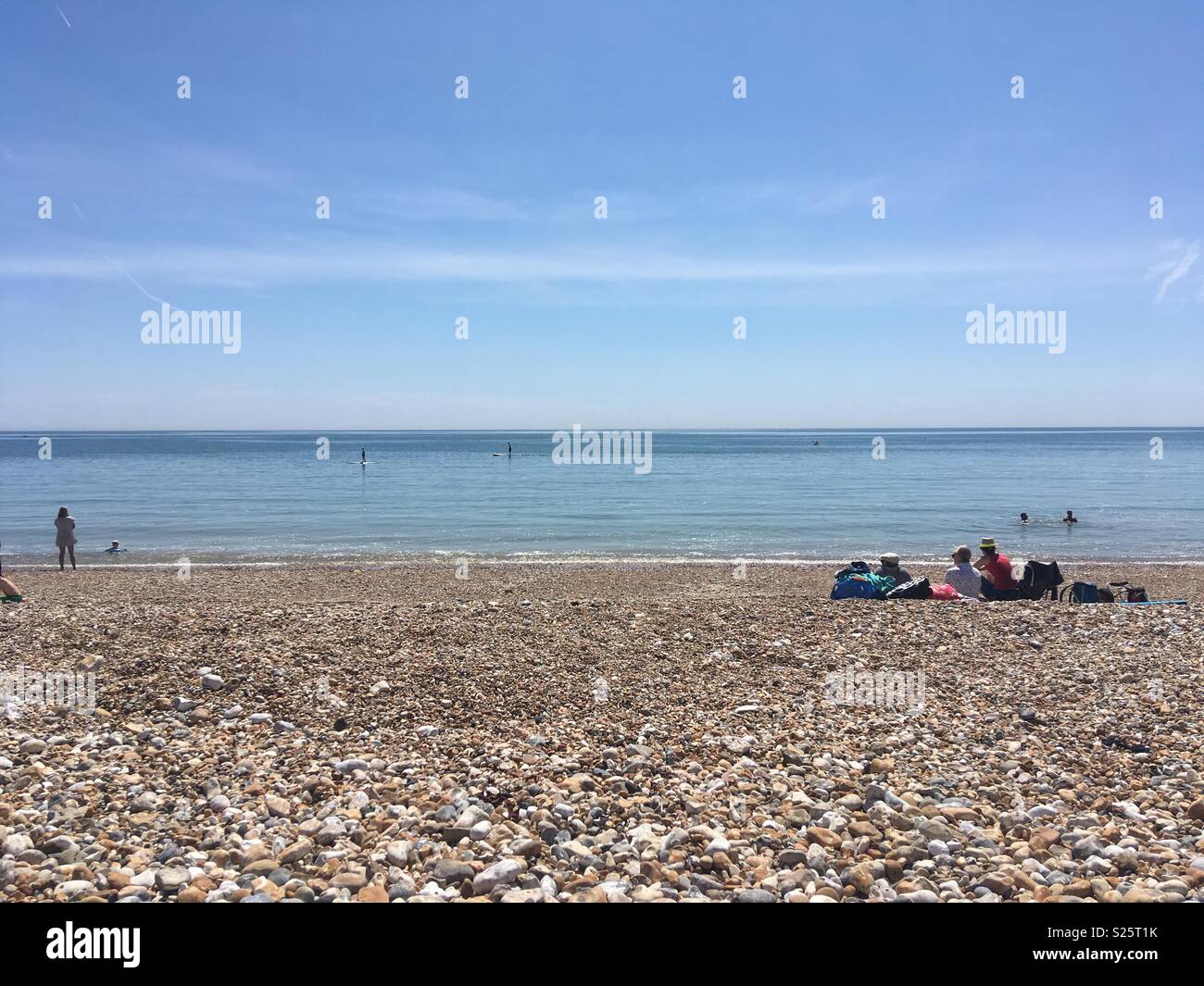 Beautiful beach on a hot sunny day with lovely calm water Stock Photo