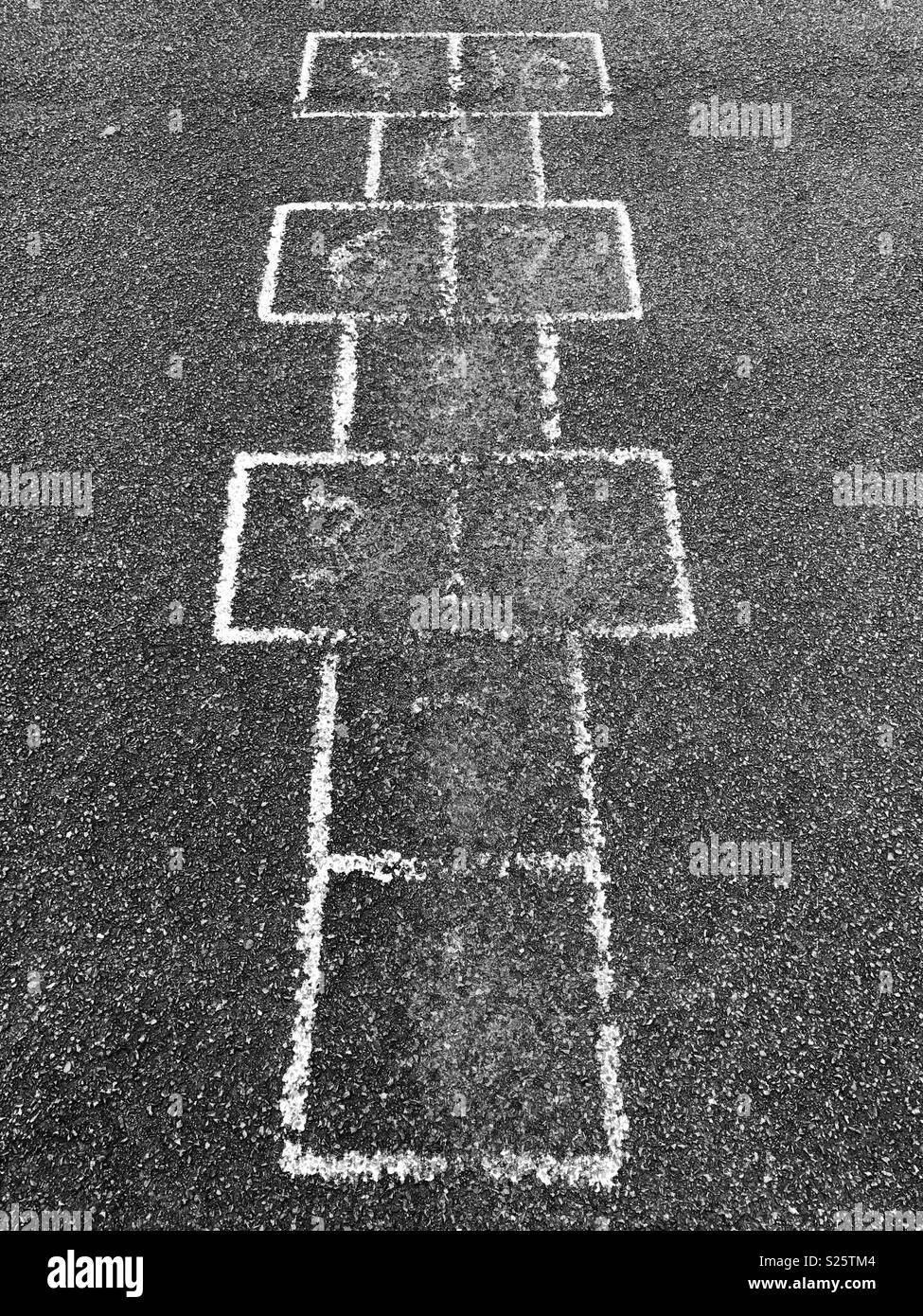 A hopscotch game in an old school playground with most of the numbers worn off. - Smartphone Captured Stock Image