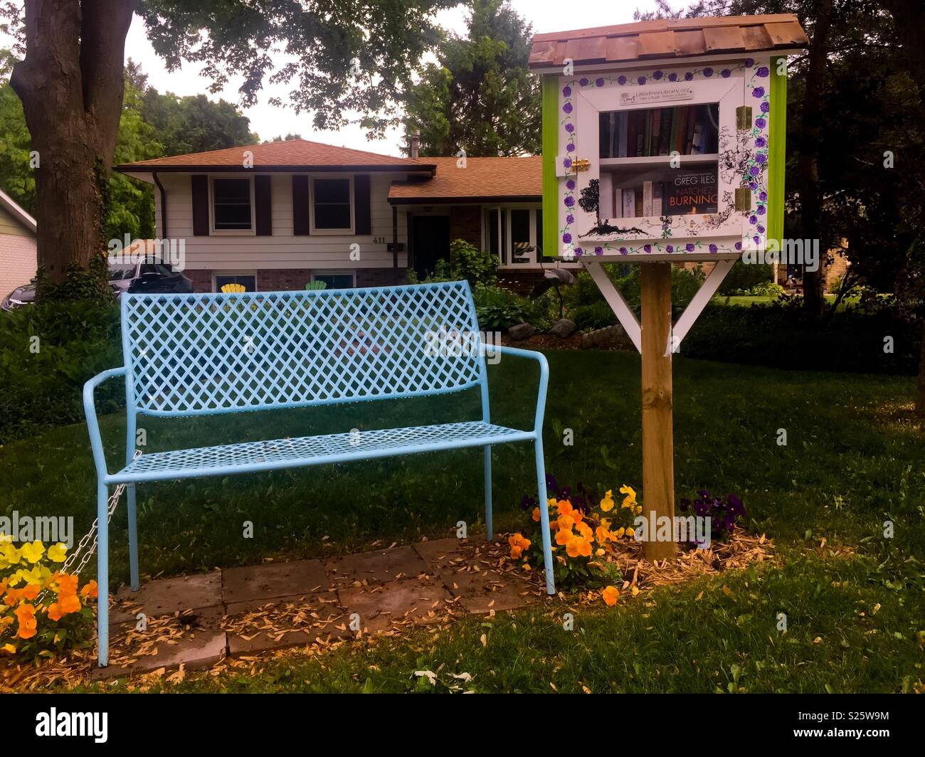 Little free library and a bench outside a home, Canada. Take books, bring some, sit for a while and browse. Worldwide movement. Smart, meaningful recycling. Saving from landfill. - Smartphone Captured Stock Image