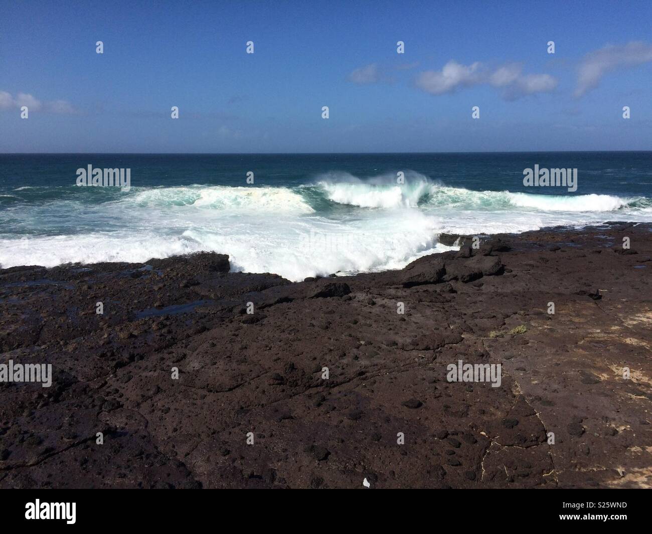 Ocean wave breaking on the rocks - Smartphone Captured Stock Image