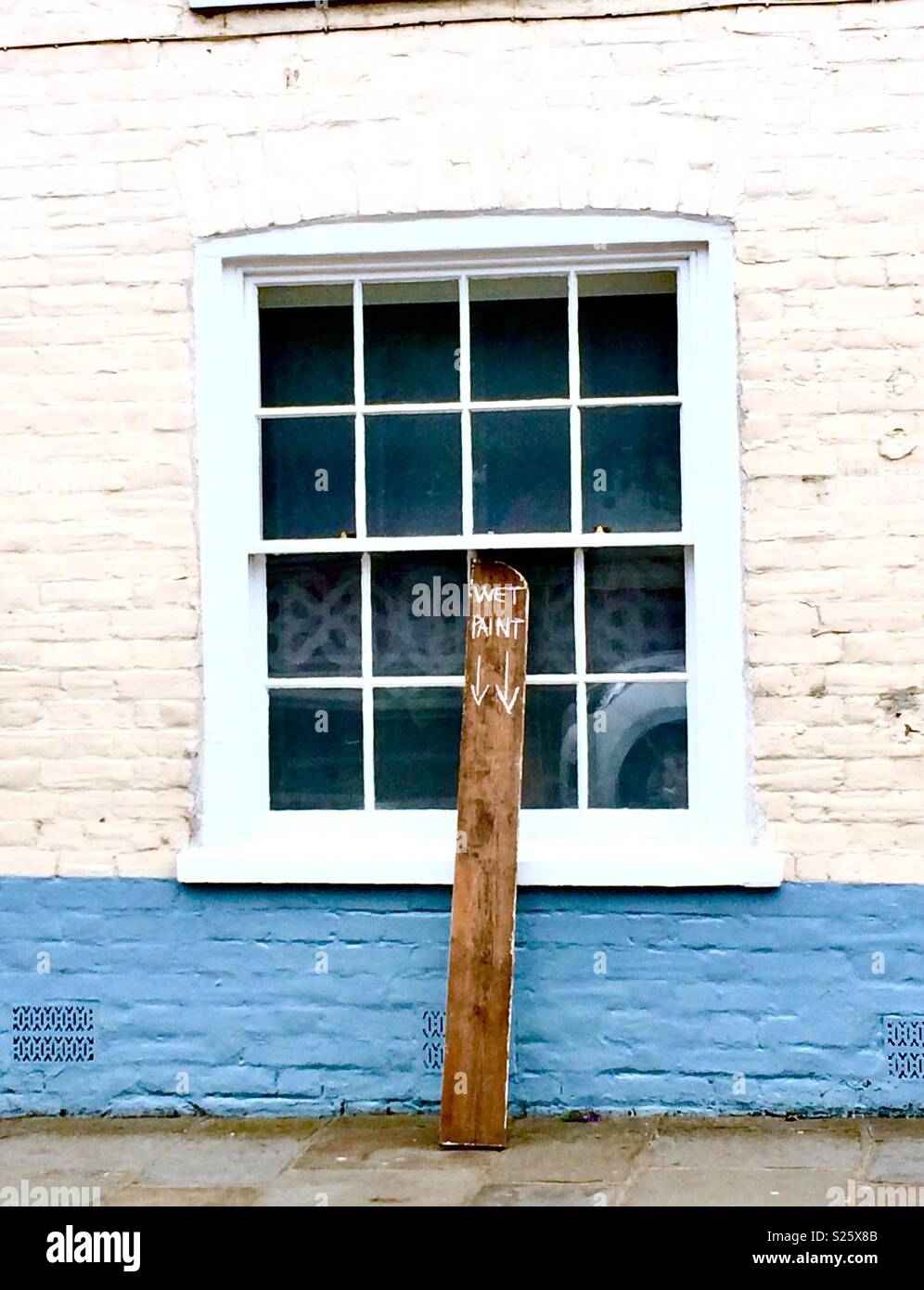 Wet paint sign chalked onto a plank of wood - Smartphone Captured Stock Image