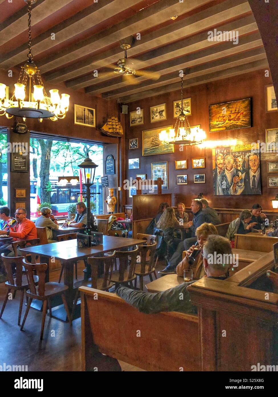 Customers enjoying a meal in one of Hamburg’s oldest establishments, Nagel. - Smartphone Captured Stock Image