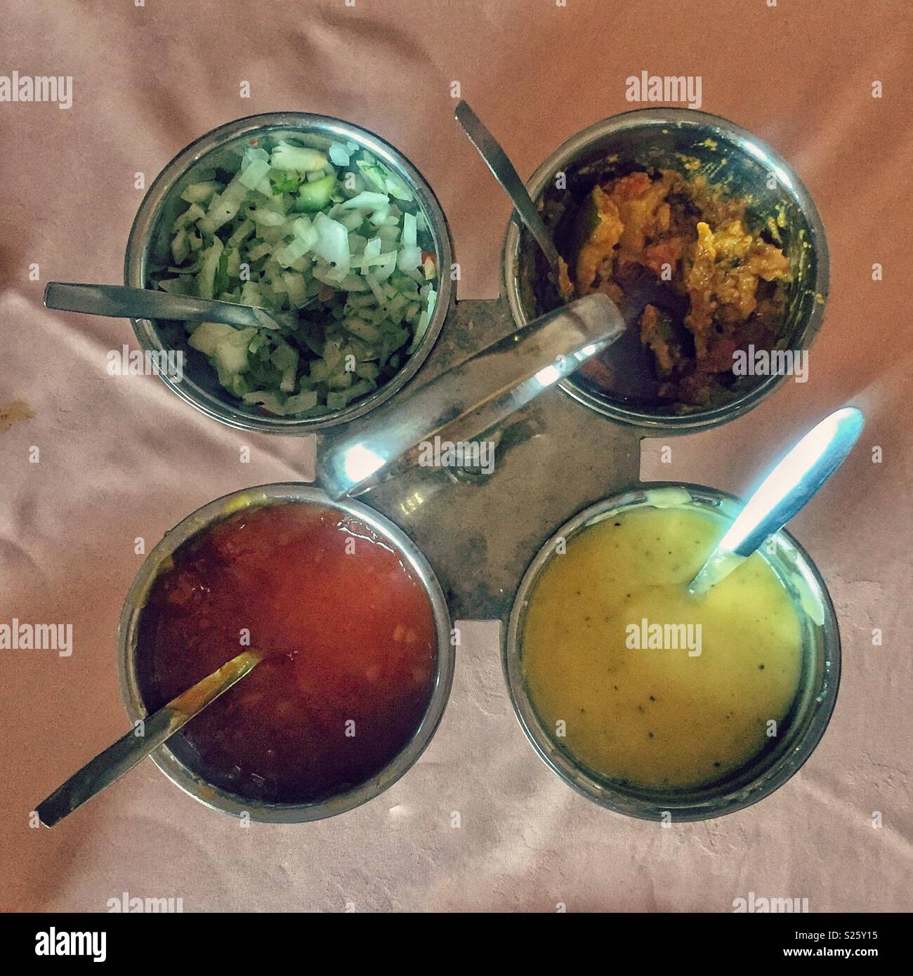 Four different chutneys and pickles in an Indian restaurant Stock Photo