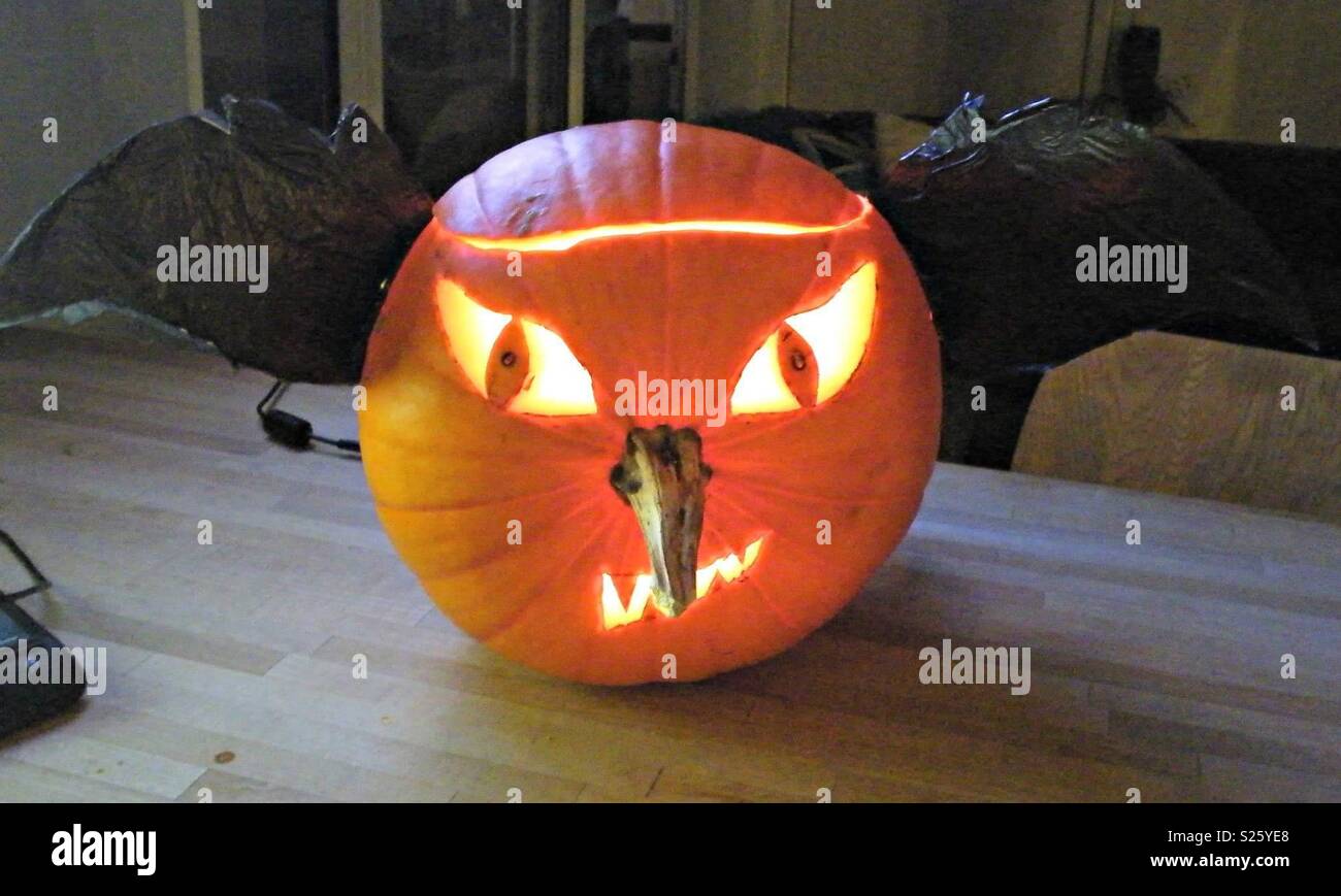 Pumpkin carved like a bat with wings and pointed nose Stock Photo