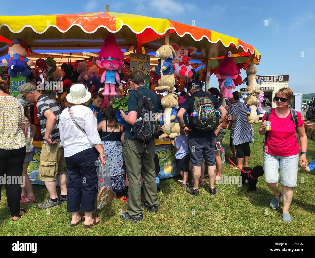 Crowd of people surrounding Hook a Duck, a side stall game at the annual Sherborne Castle Country Fair, Sherborne, Dorset, England Stock Photo