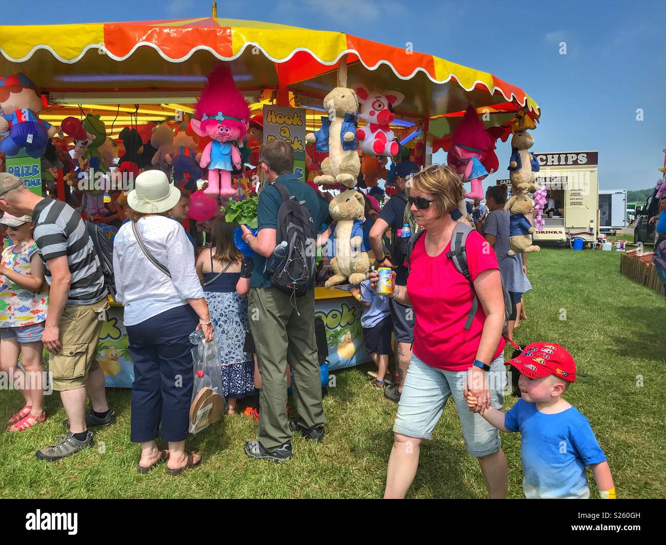 Crowd of people surrounding Hook a Duck, a side stall game at the annual Sherborne Castle Country Fair, Sherborne, Dorset, England - Smartphone Captured Stock Image