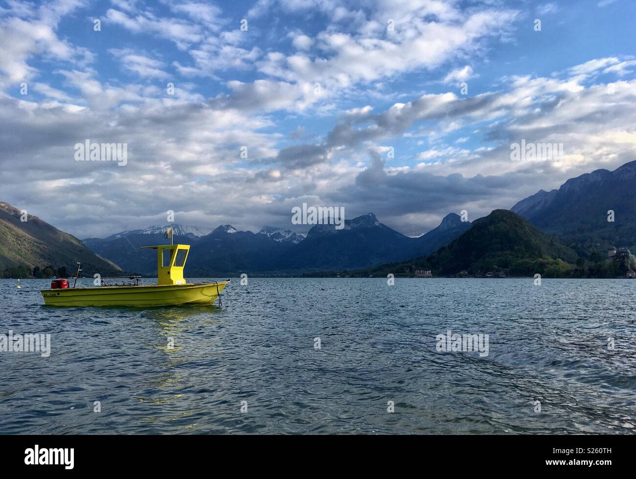 Yellow boat on Lake Annecy, France Stock Photo