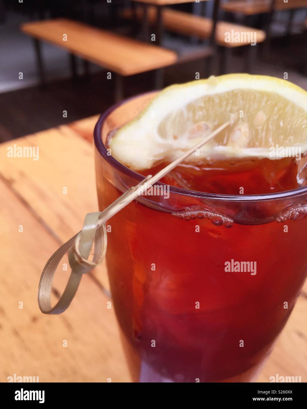 Tall refreshing glass of iced tea with a large lemon wedge, USA Stock Photo