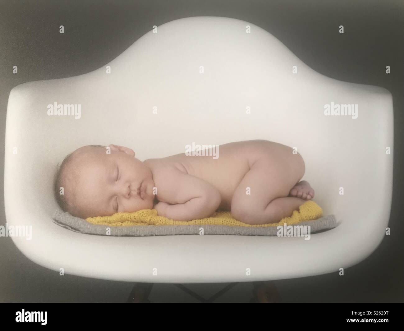 Baby sleeping on a chair Stock Photo