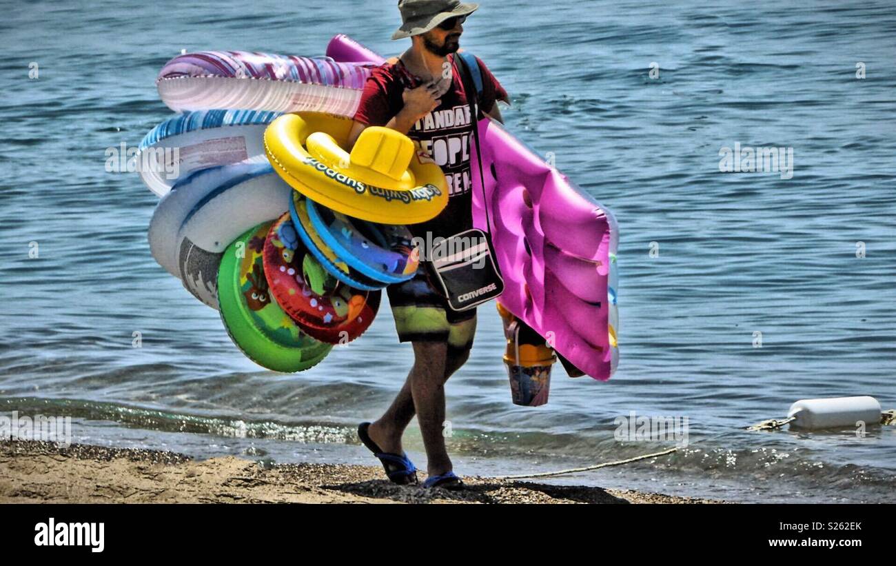 The seller of swimming belts and  rubber animals. - Smartphone Captured Stock Image