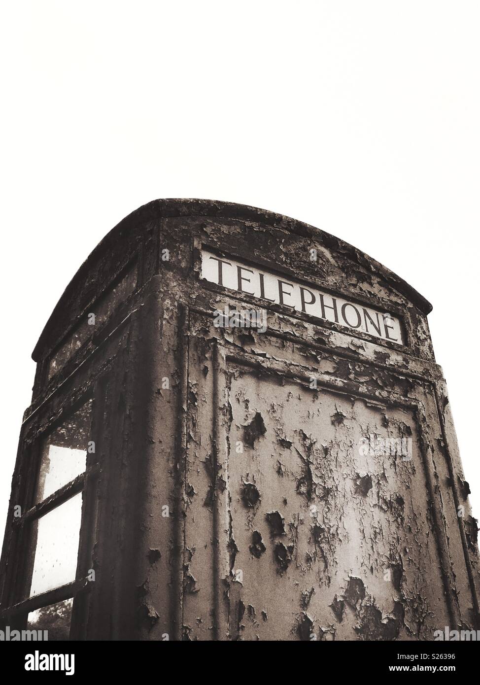 An old vandalised telephone box in black and white - Smartphone Captured Stock Image