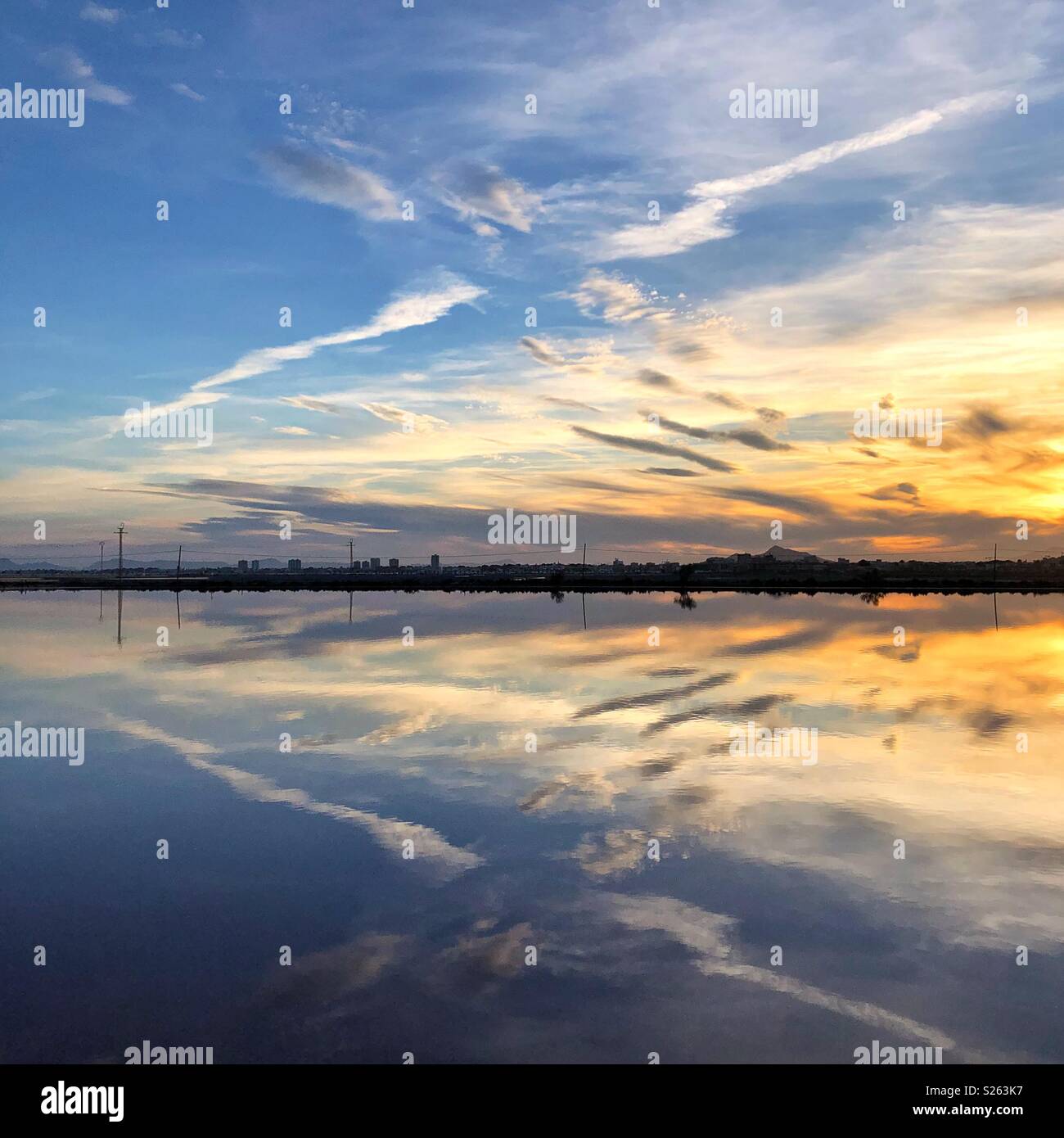 Reflections in the salt lakes at sun set. - Smartphone Captured Stock Image