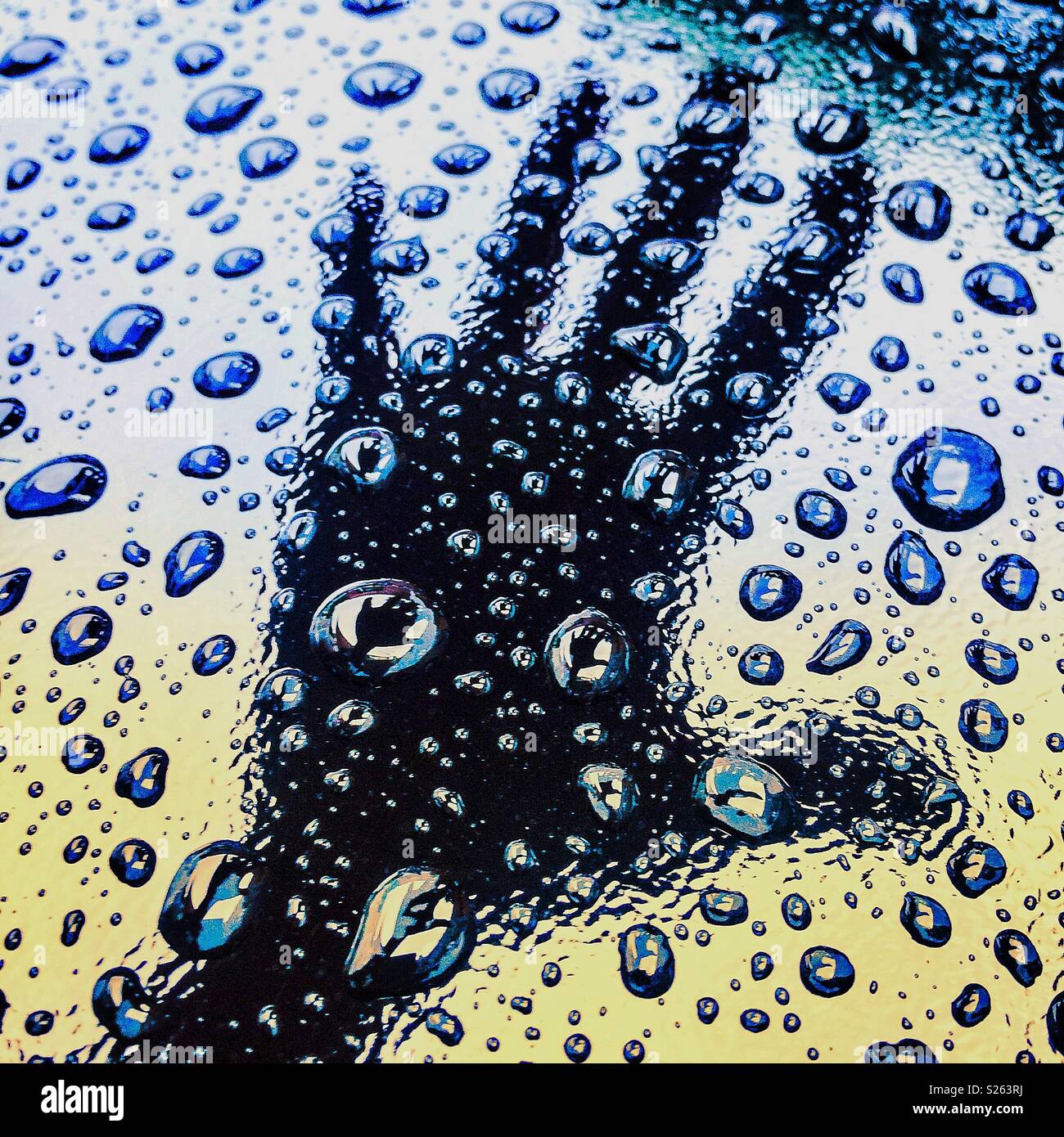 STOP open hand reflected on top raindrops after raining - Smartphone Captured Stock Image