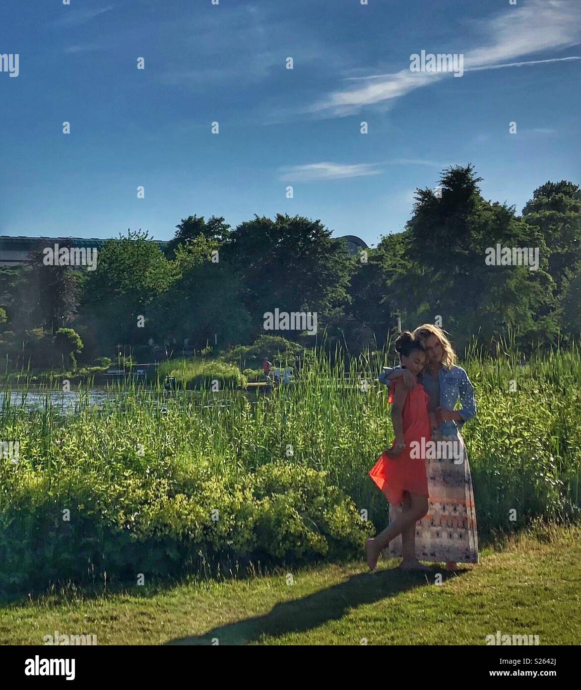 Two friends posing for a photo in a park. - Smartphone Captured Stock Image