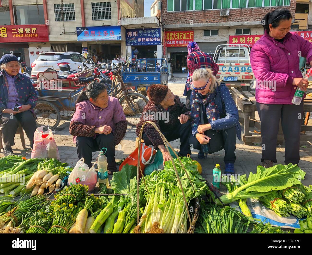 Women chatting at an outdoor market in rural China. - Smartphone Captured Stock Image