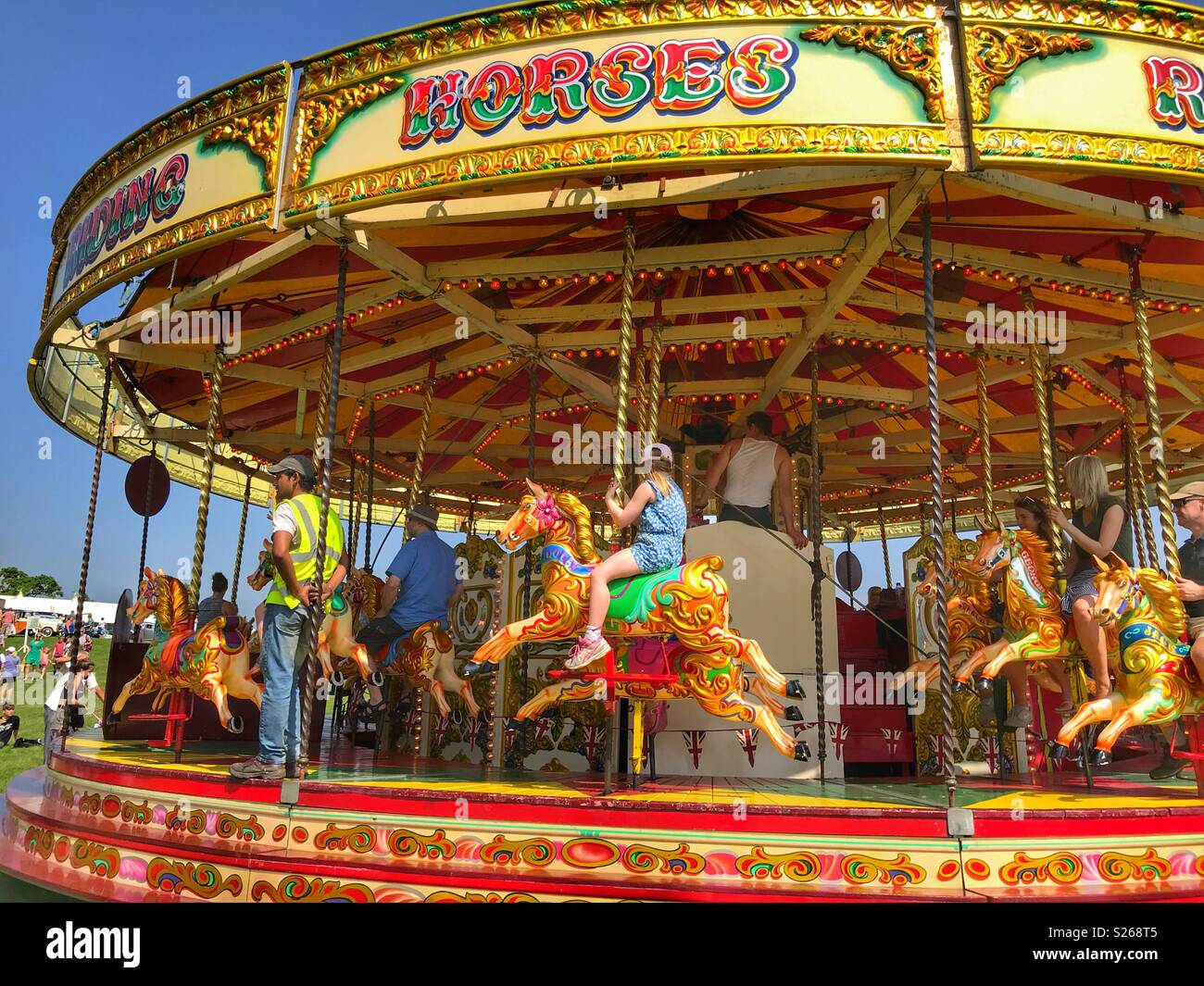 Fairground rides, merry-go-round at Sherborne Castle Country Fair, Sherborne, Dorset, England - Smartphone Captured Stock Image
