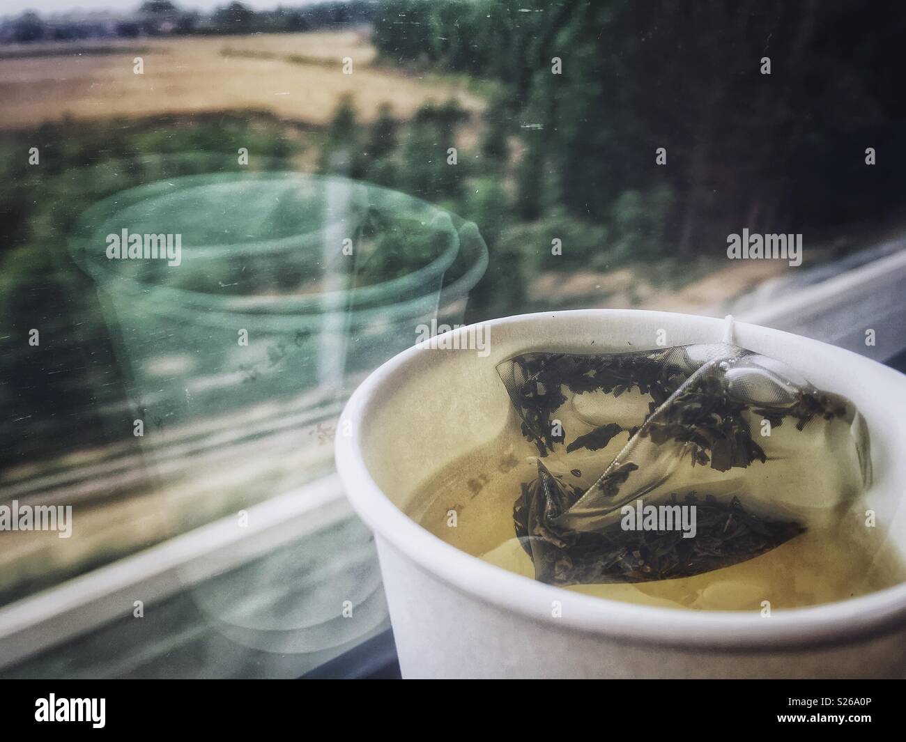 Tea time in a fast train - Smartphone Captured Stock Image