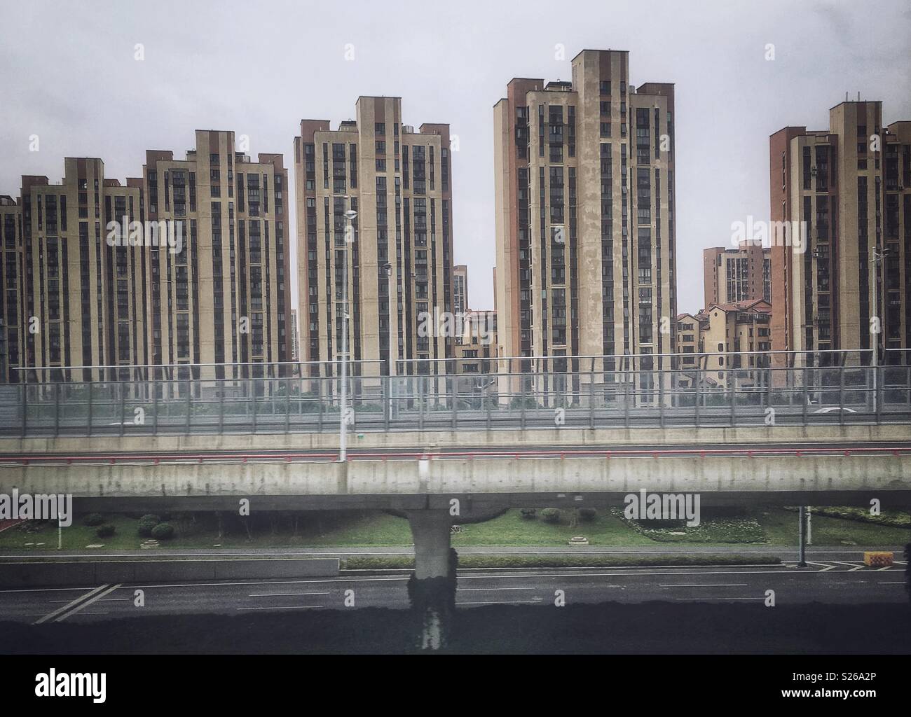Skyline of a identical skyscrapers and highway bridge in China. Stock Photo