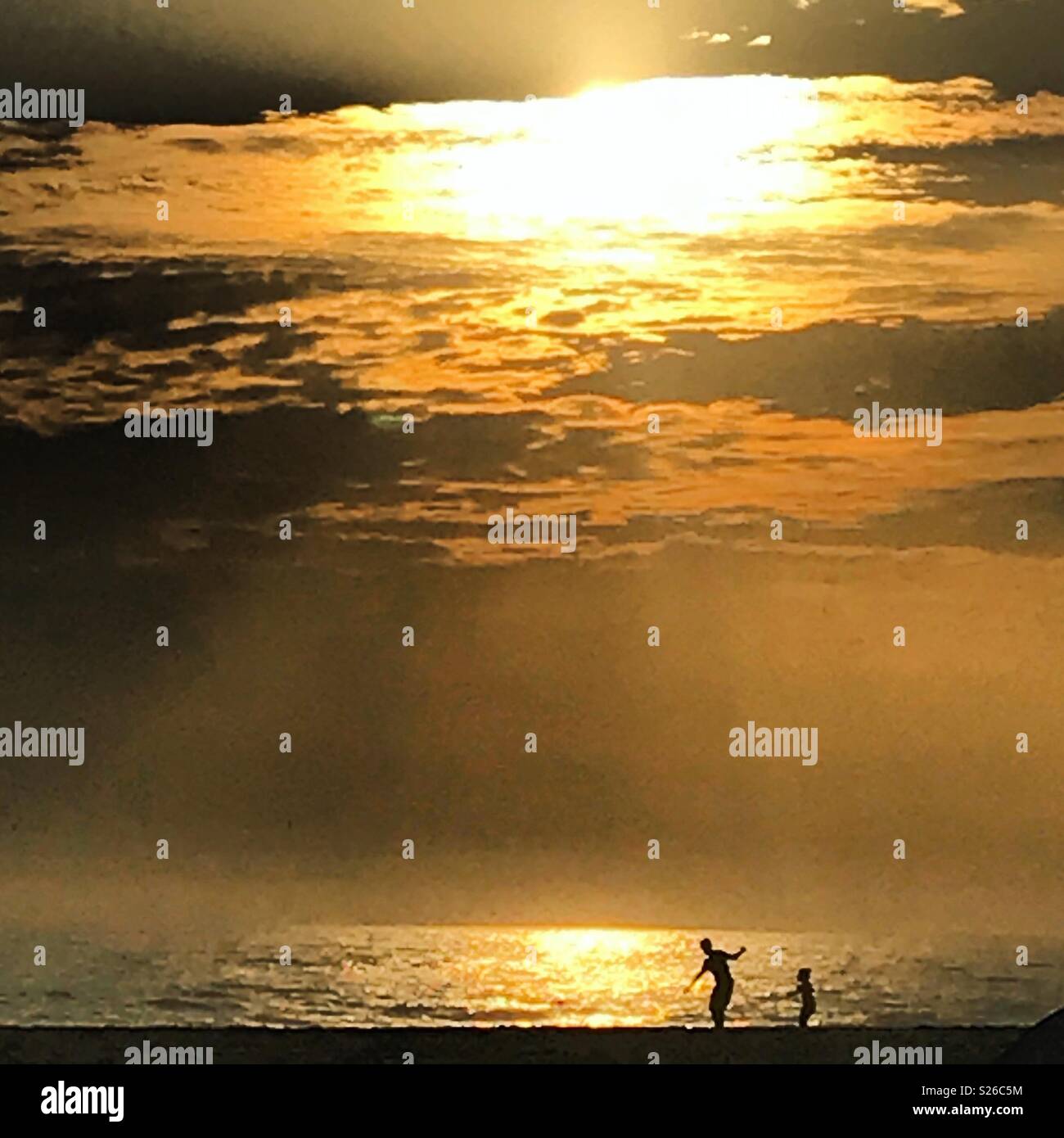 A father and his son play in the beach in Todos Santos, Baja California, Mexico - Smartphone Captured Stock Image