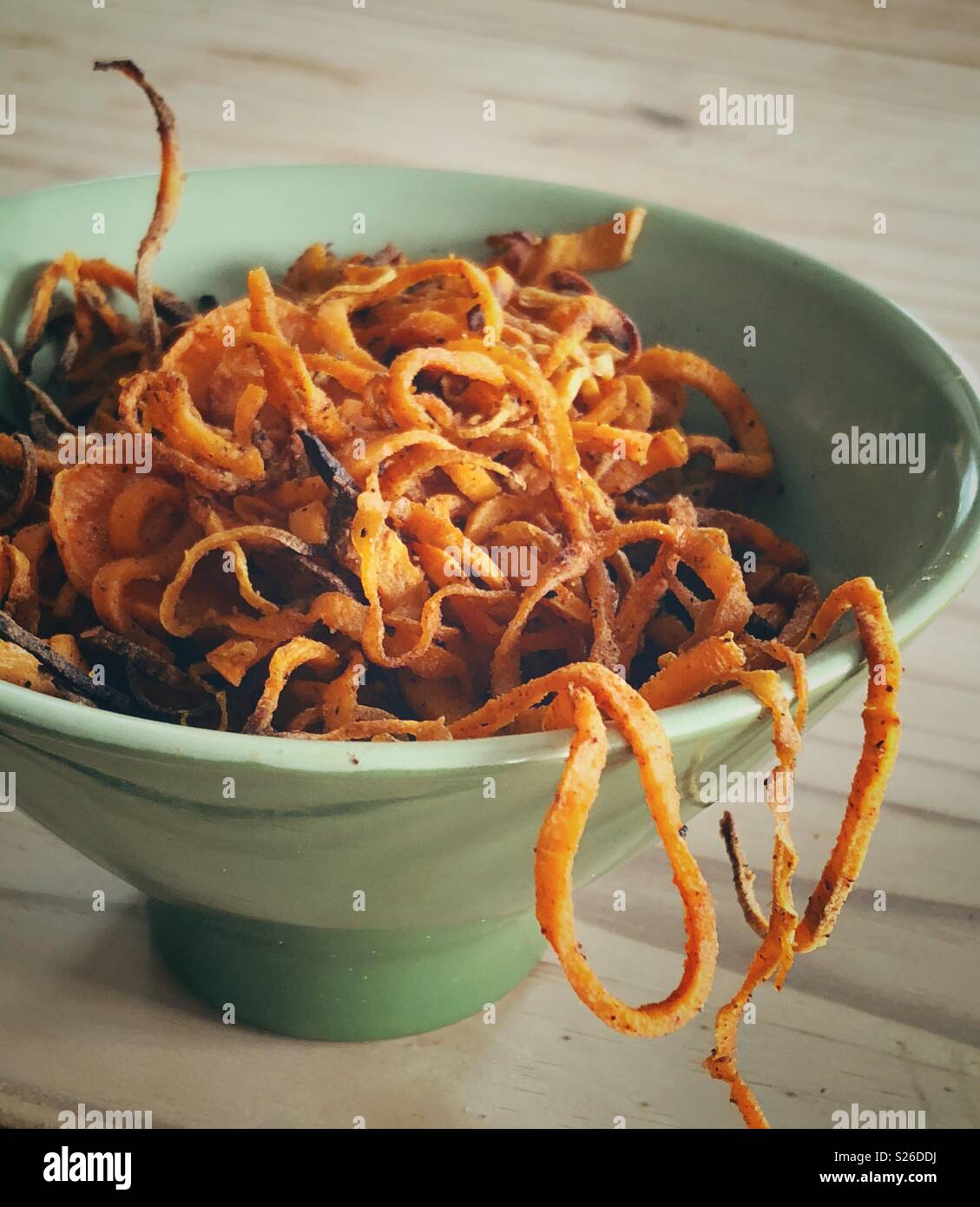 Closeup image of bowl full of cooked, spiralized sweet potato noodles - Smartphone Captured Stock Image