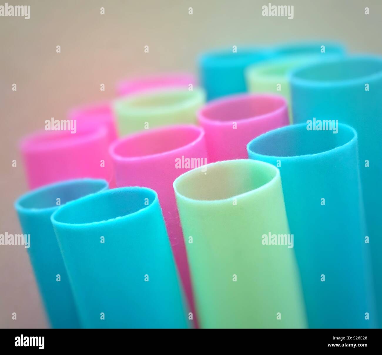 Macro closeup of brightly coloured blue, pink and greenish yellow plastic drinking straws - Smartphone Captured Stock Image
