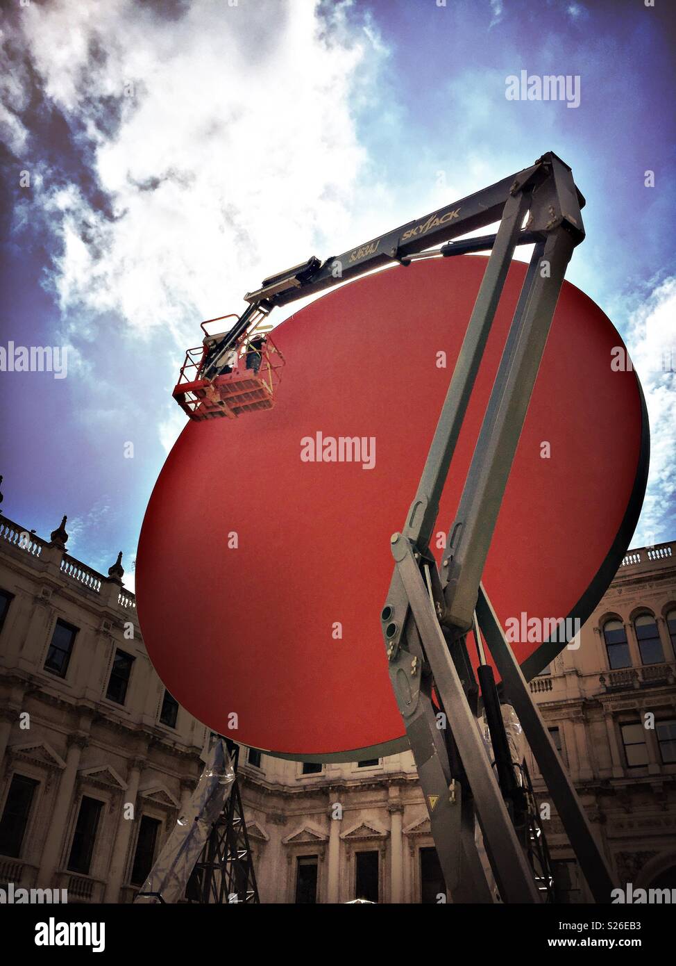 Finishing touches added to the new Anish Kapoor sculpture installation in the courtyard at The Royal Academy of Arts. - Smartphone Captured Stock Image