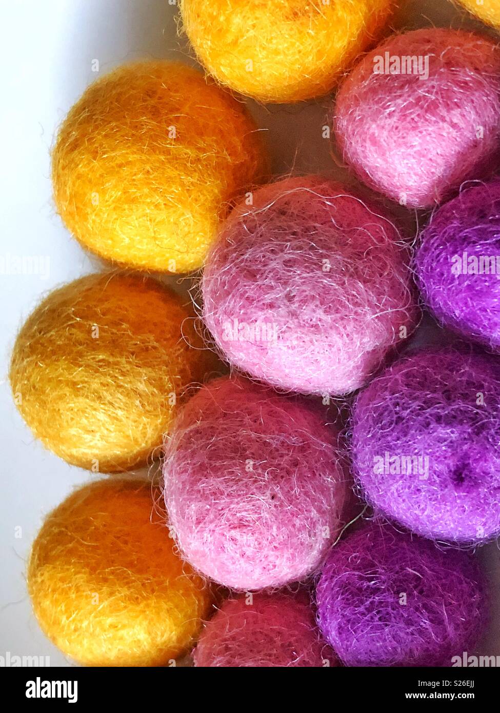 Yellow , pink and purple wool felted balls Stock Photo