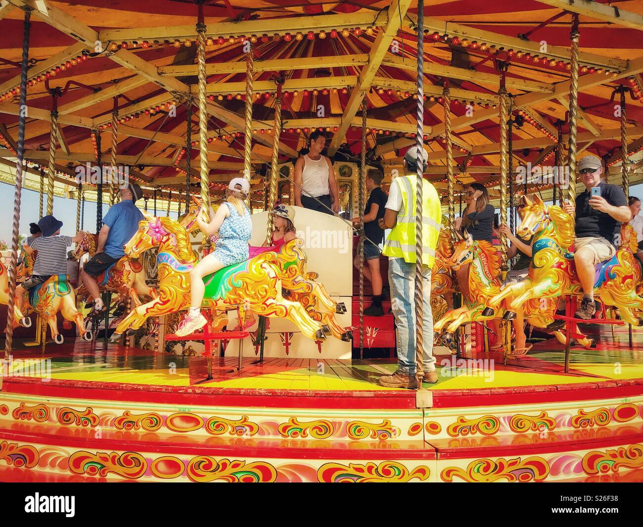 Traditional merry-go-round, carousel with colourful horses, Sherborne Castle Country Fair, Sherborne, Dorset, England Stock Photo